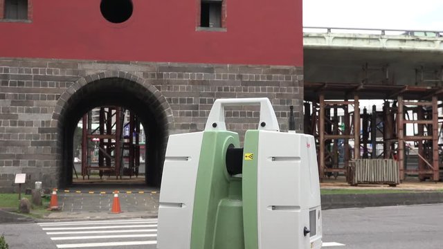 A total station theodolite is working in the North Gate of Taipei (Cheng-en Gate) before the demolition of the Zhongxiao Elevated Highway. 4K