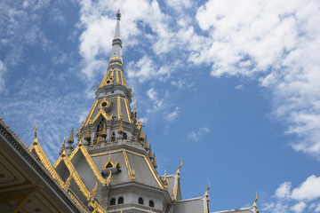 Beautiful thai-style temple roof over blue sky