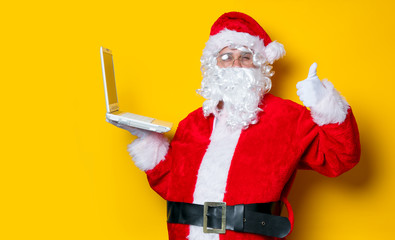 Funny Santa Claus have a fun with laptop