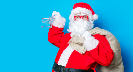 Funny Santa Claus have a fun with shopping cart