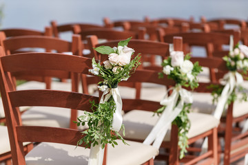 wedding decorated wooden chairs with flowers