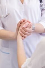 Hand of doctor reassuring her patient