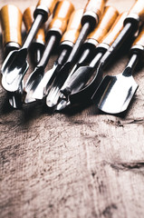 A set of chisels on a old wooden table