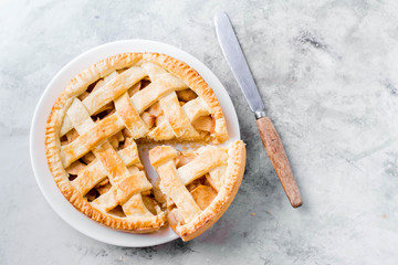 Popular American apple pie on gray table. Homemade classical friut tart. Copy space