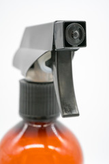 Close up black plastic nozzle of brown transparent spray bottle