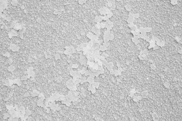 Natural salt texture on the coast of the lake. Abstract nature pattern of mineral salt for your white background.