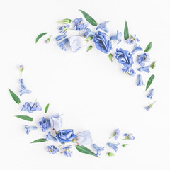 Fototapeta na wymiar Flowers composition. Wreath made of blue flowers on white background. Flat lay, top view