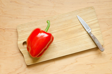 Juicy red pepper on the kitchen board