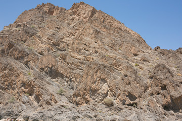 Geological folds in the mountains along the Wadi Al-Arbaeen in Oman