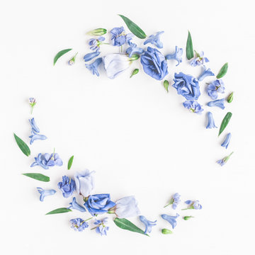 Fototapeta Flowers composition. Wreath made of blue flowers on white background. Flat lay, top view