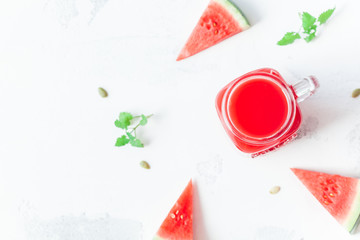 Watermelon juice and watermelon slices on white background. Summer concept. Top view, flat lay, close up