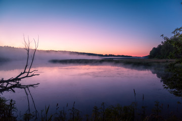Foggy morning. Lake before sunrise. Rural landscape, mystical feeling