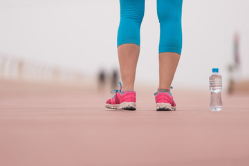 close up on running shoes and bottle of water