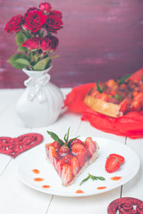 Strawberry pie on whire plate and white wooden table. One piece.  Romantic. Love. Heart.