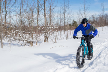 Man riding his fat bike in the snow