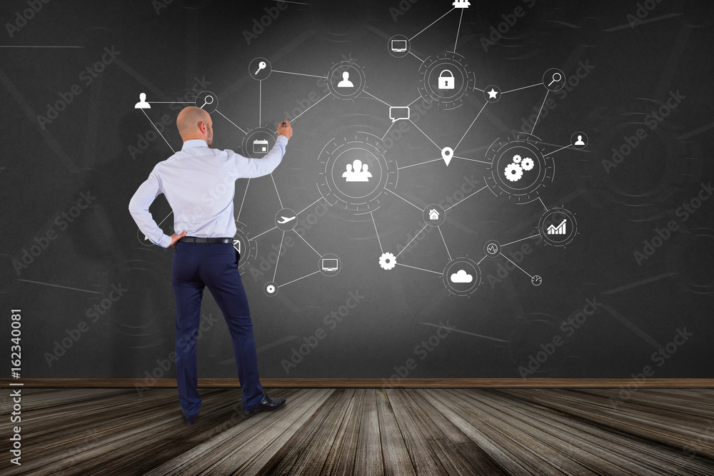 Poster businessman in front of a wall with a business network connection displayed on a futuristic interfac
