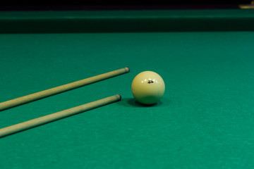 Two cues on the table. End of the game. Billiard club
