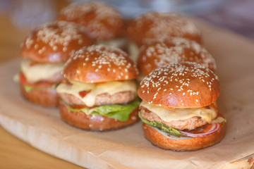 Fresh homemade burgers on wooden serving board . Slective focus, copy space