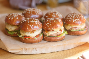 Fresh homemade burgers on wooden serving board . Slective focus, copy space