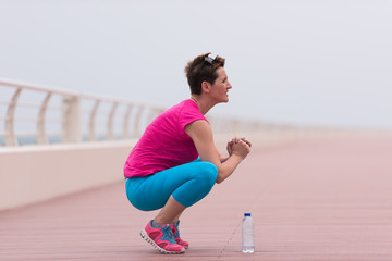 woman stretching and warming up on the promenade