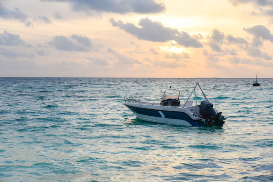 Motor boat in sea with sunset at Maafushi Island,Maldives