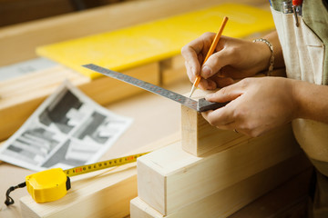 Craftsman measure wooden planks with help of ruler. Woodworker workshop