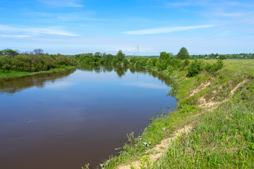 View on river valley with growth on bank

