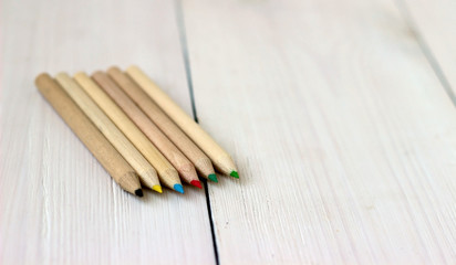 Close up color pencils on wooden table, concept of art and education