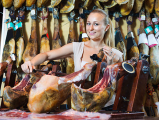 Positive  female customer choosing iberian ham