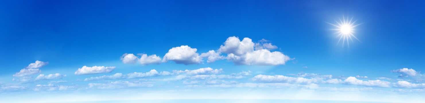 Panorama of a blue sky with clouds and sun