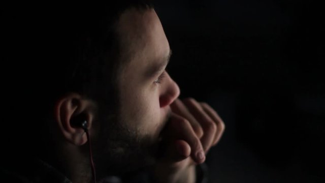 Young Man Back light Looks At Computer Display with Internet Browser