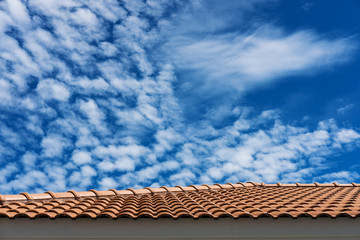 Roof tiles with blue sky and white clouds