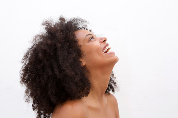 Side portrait of laughing black woman with bare shoulders