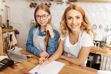 Mother and daughter drafting a business plan for their cafe