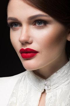 Beautiful girl with red lips in white clothes in the form of retro. Beauty face. Picture taken in the studio