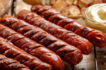 Grilled sausages in oven pan with garlic and onion