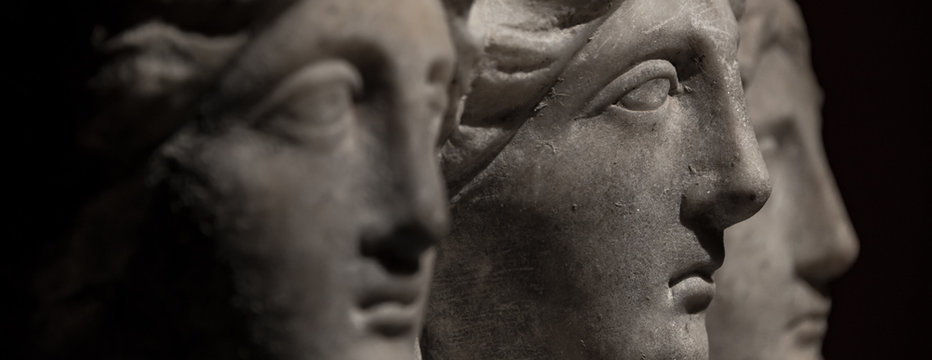 Three headed roman-asian ancient statue of beautiful women at black background
