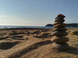 Zen stones stacked on the beach