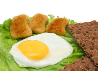 Breakfast copy space: fried egg, lettuce, crisp bread and nuggets