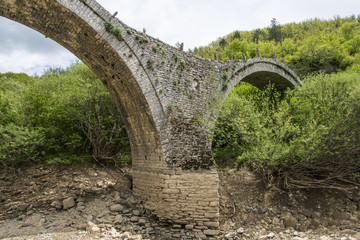 Fototapeta na wymiar Kalogeriko triple arched stone bridge, Greece