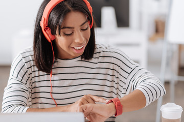 Pleasant delighted woman checking the time