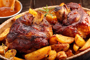 Grilled barbecue meat with baked potato and dip