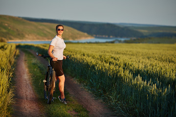 woman with bike enjoy summer vacation in the beautiful meadow