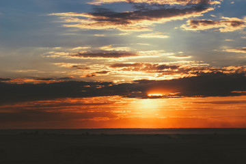 Great sunset in the field with clouds