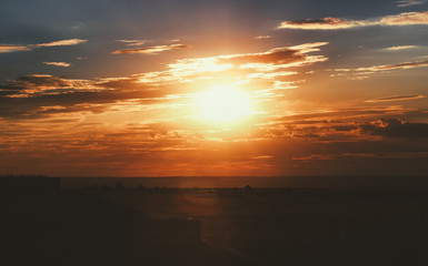 Beuty sunset in the field with amazing clouds