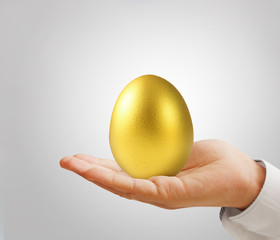 Hand Holding of golden eggs