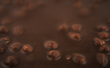 Chocolate background. Milk chocolate with hazelnuts close-up.