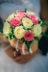 the bride holding a bouquet of multicolored roses