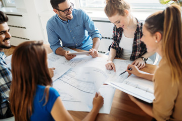 Image of business partners discussing documents and ideas