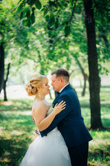 couple bride and groom on the background of the park's trees